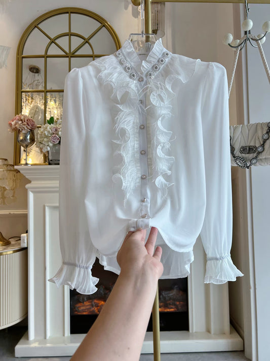 Women's two-piece set featuring a loose-fitting, long-sleeved chiffon blouse adorned with feathers, ruffles, and intricate rhinestone embellishments, plus a matching top.