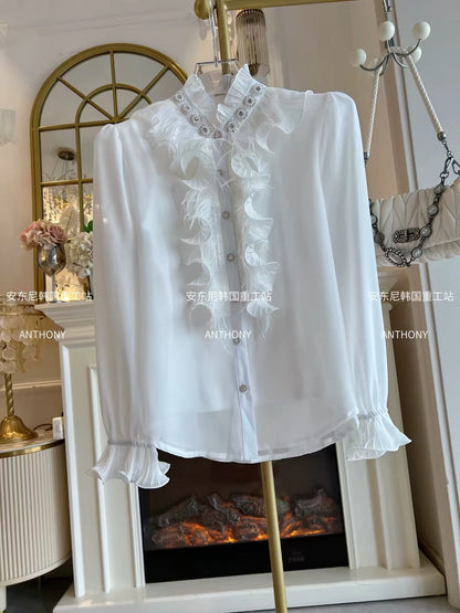 Women's two-piece set featuring a loose-fitting, long-sleeved chiffon blouse adorned with feathers, ruffles, and intricate rhinestone embellishments, plus a matching top.