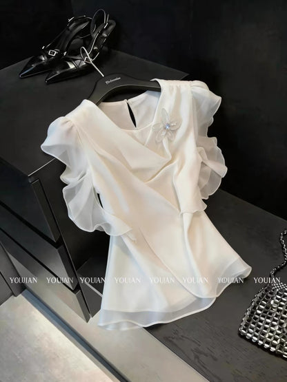 French chic and sophisticated design: a chiffon blouse with a flowing neckline, three-dimensional floral ruffles, and short sleeves.