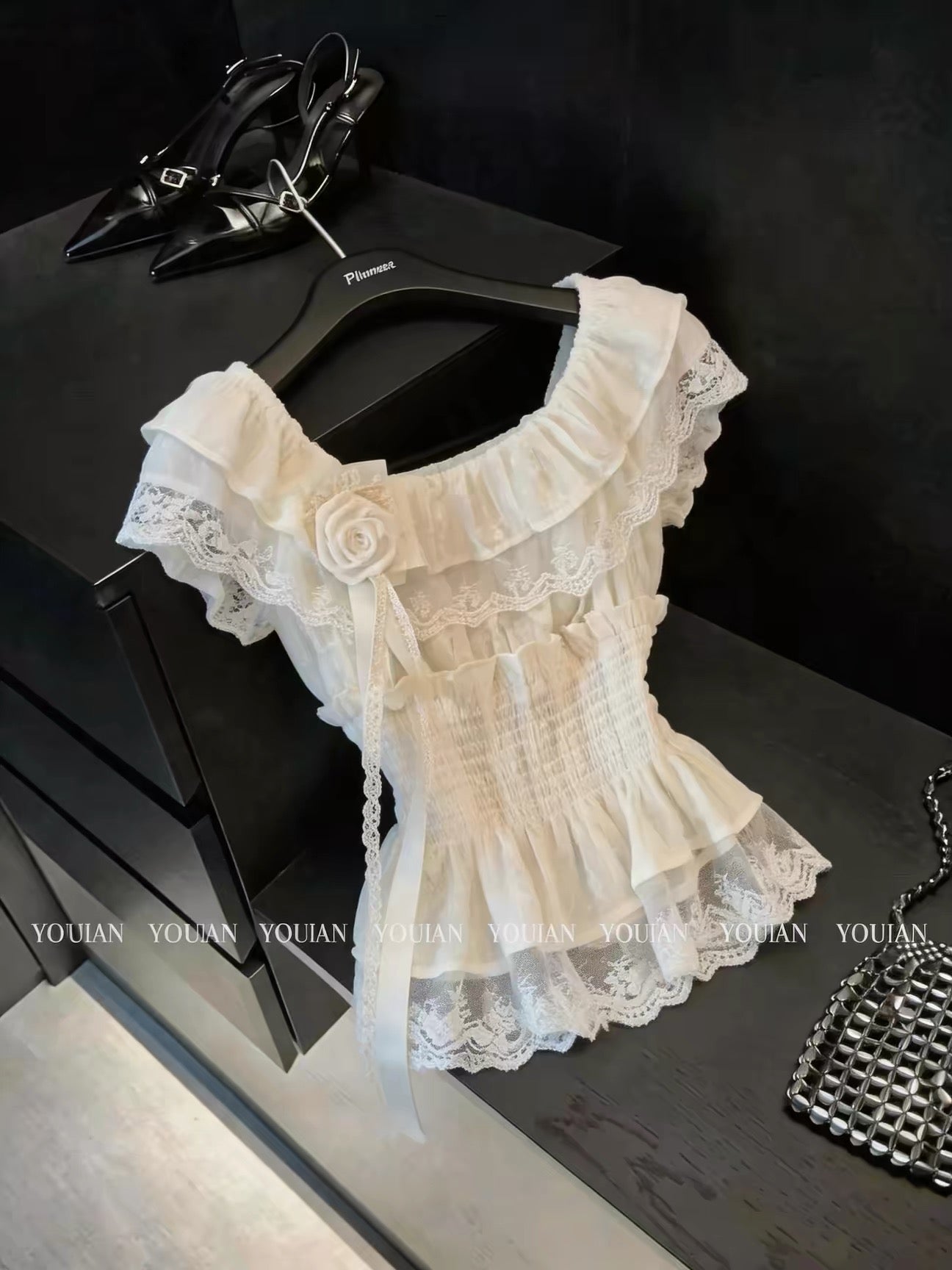 French-style chic, pretty off-the-shoulder short-sleeved blouse with ruffles and three-dimensional flowers; sophisticated, unique, and ethereal.