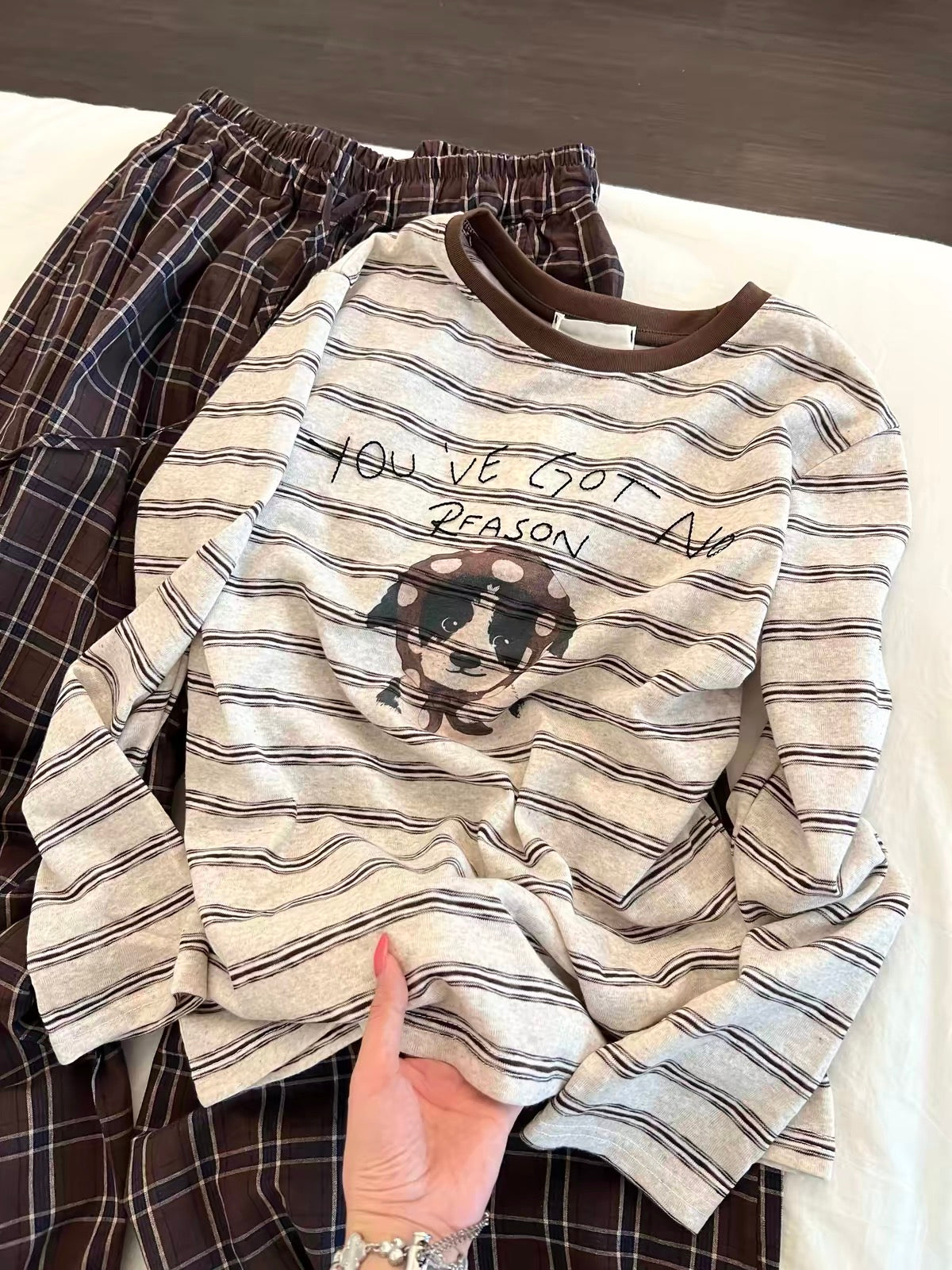 Korean-style relaxed-fit long-sleeved pajama set for women: features a striped top with a puppy print and plaid trousers—suitable for lounging or casual wear.