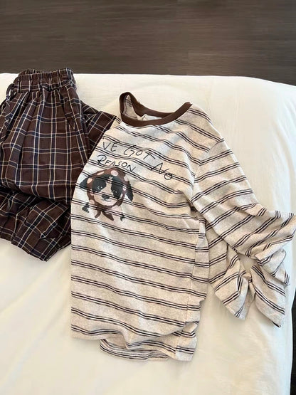 Korean-style relaxed-fit long-sleeved pajama set for women: features a striped top with a puppy print and plaid trousers—suitable for lounging or casual wear.