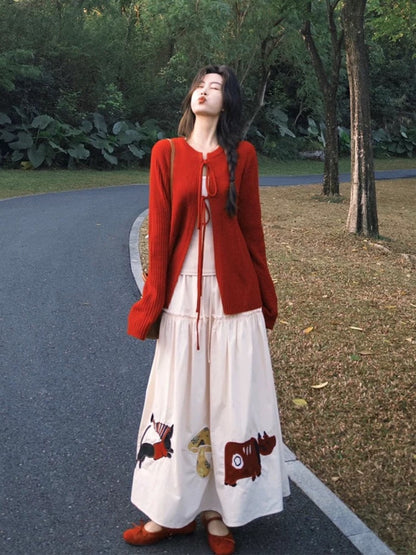 Autumn OOTD outfit: A sophisticated Korean-style two-piece set featuring a red tie-up knit cardigan and cartoon skirt.