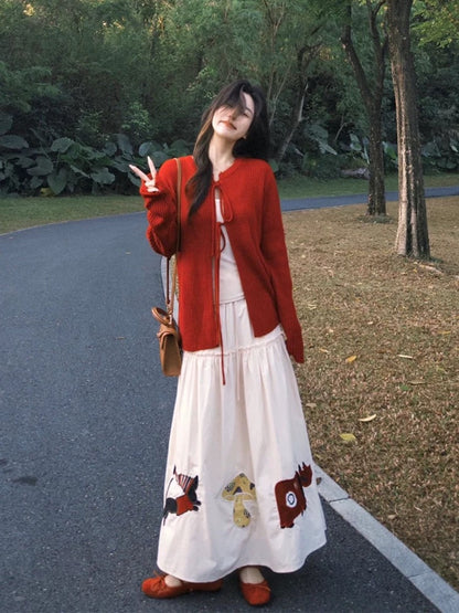 Autumn OOTD outfit: A sophisticated Korean-style two-piece set featuring a red tie-up knit cardigan and cartoon skirt.