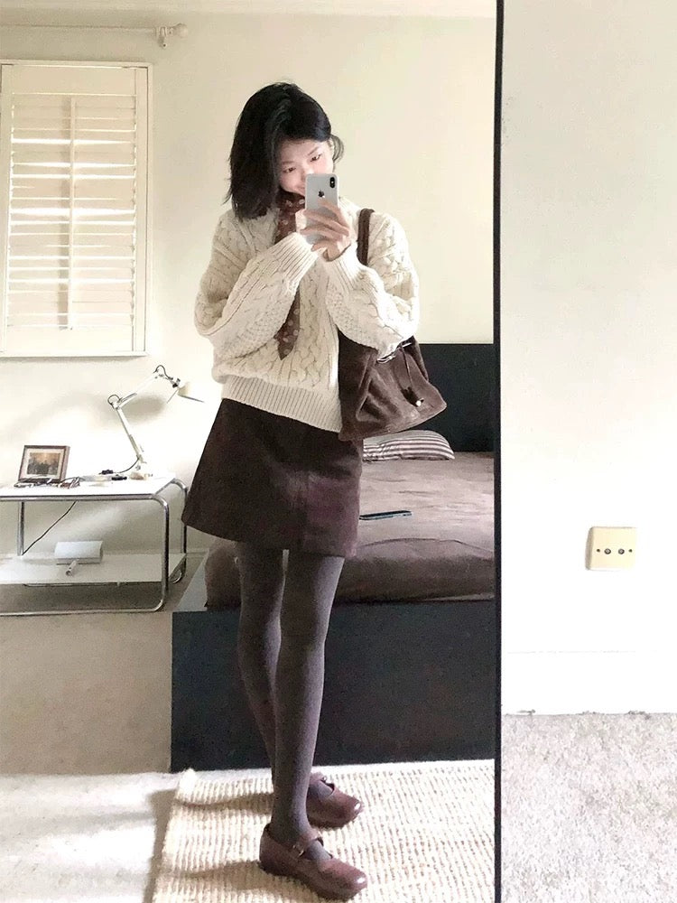A sophisticated two-piece winter outfit: a preppy Korean-style cable knit sweater and skirt set.