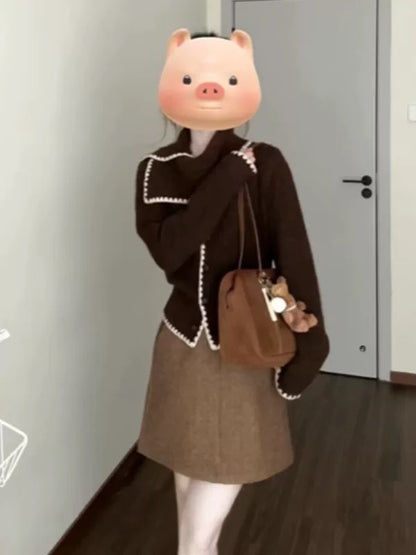 A complete autumn/winter outfit: a sophisticated scarf, turtleneck sweater, knitted cardigan, and skirt set—a unique and beautiful set.