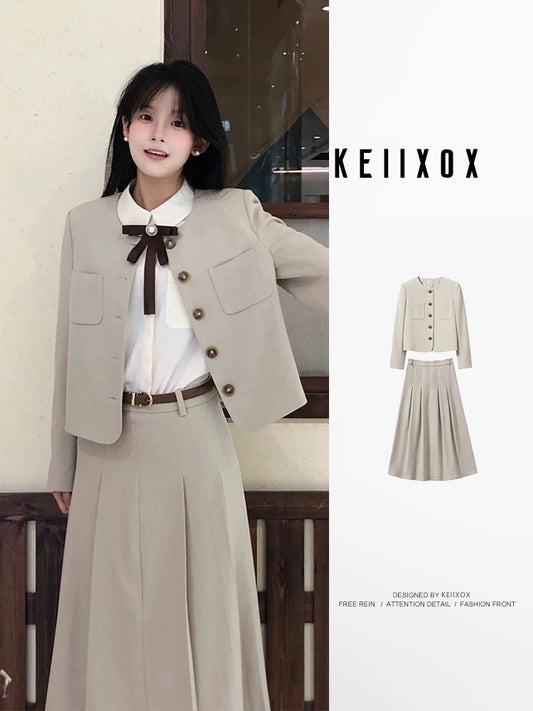 A sophisticated Korean-style preppy two-piece winter outfit set featuring a blazer and pleated skirt.