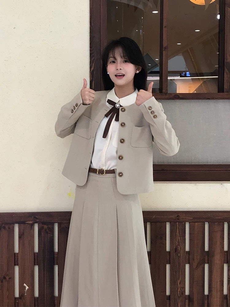 A sophisticated Korean-style preppy two-piece winter outfit set featuring a blazer and pleated skirt.