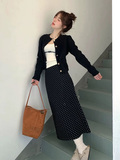 A complete Korean-style outfit for petite women, featuring a knitted cardigan and polka-dot skirt, perfect for early spring 2025.