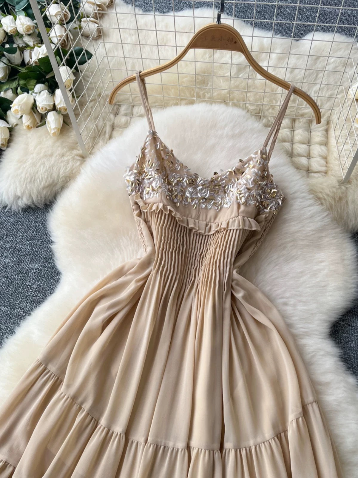 Gentle and elegant French-style spaghetti strap dress with sequin embroidery, fitted waist, slimming effect, and ethereal ruffle hem.