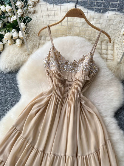 Gentle and elegant French-style spaghetti strap dress with sequin embroidery, fitted waist, slimming effect, and ethereal ruffle hem.