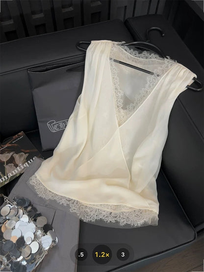 French-style lace-trimmed vest with mesh crossover design, a gentle V-neck sleeveless top perfect for summer 2025.