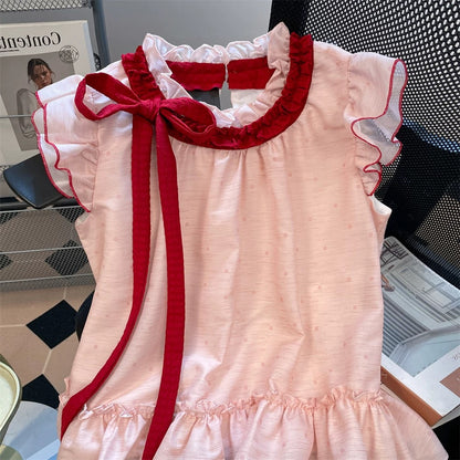 This year's beautiful tie-neck polka dot shirt, a new summer style for men and women, featuring a sweet and stylish pink color and flutter sleeves.