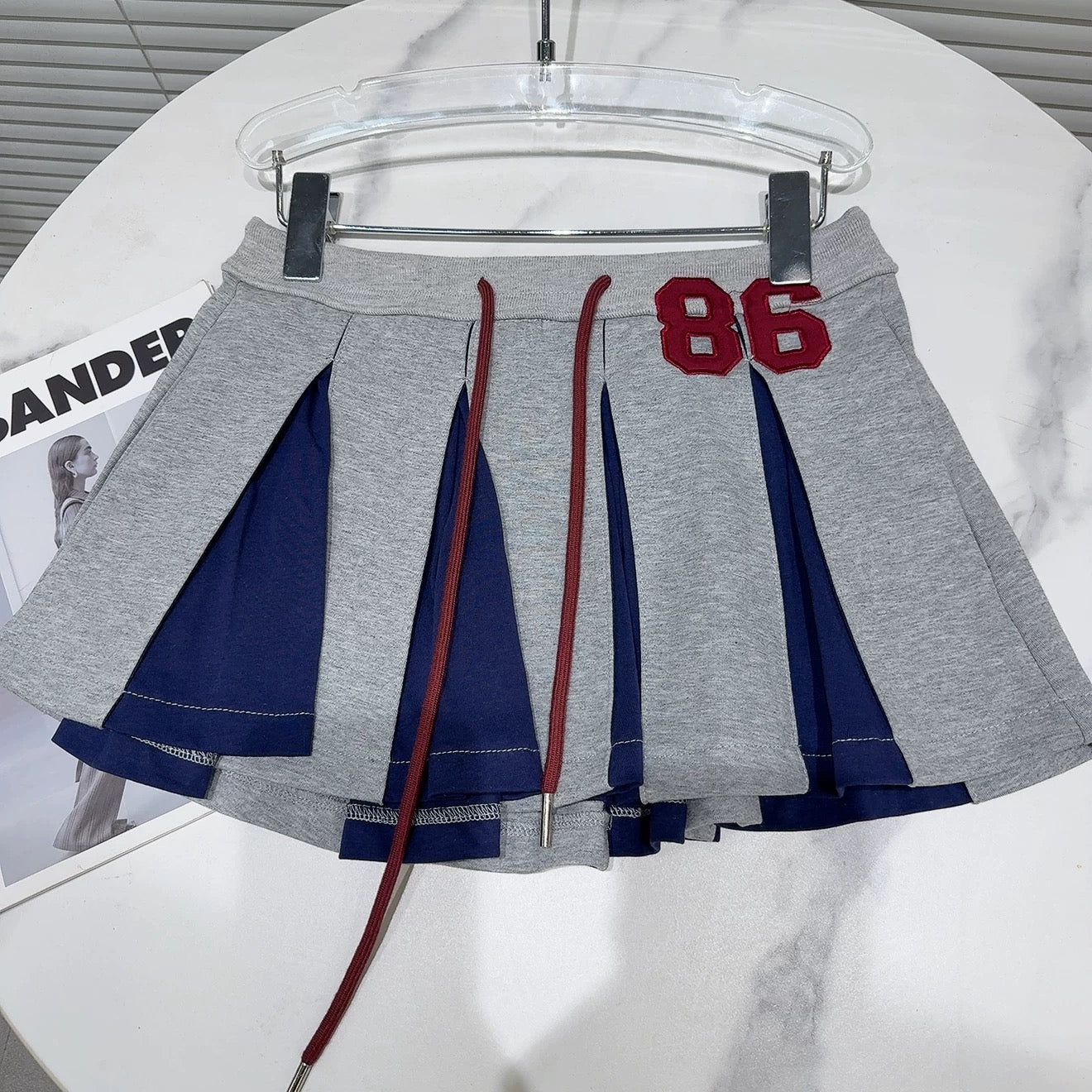 Internet celebrity style 2025 summer new niche characteristics letter patch contrast color drawstring pleated skirt short skirt A-line skirt