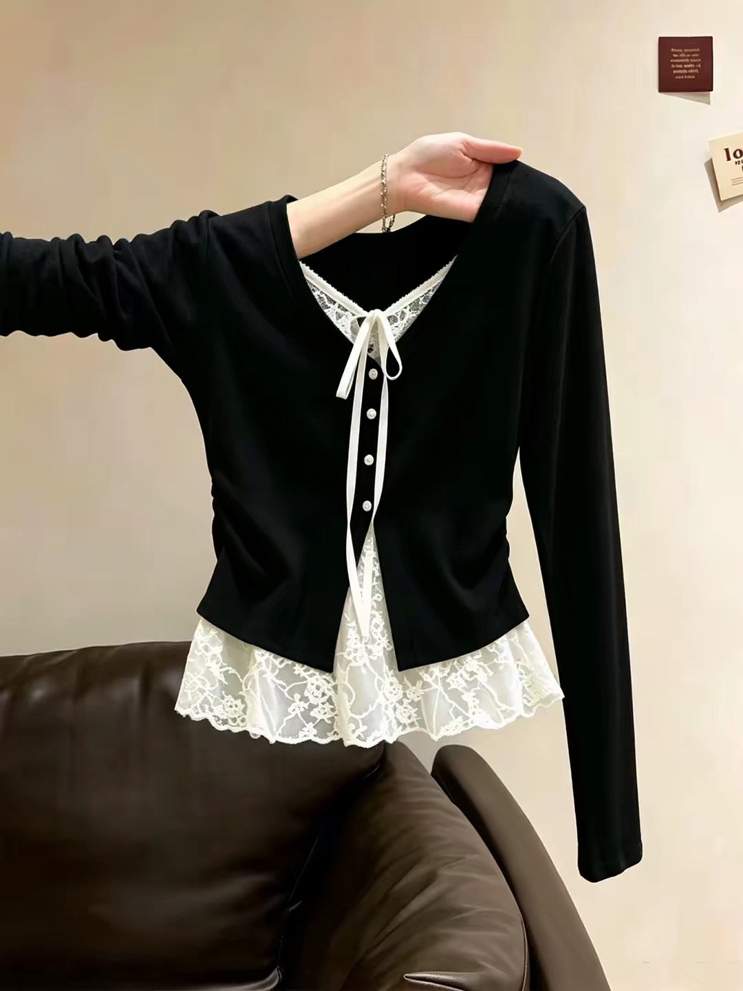Korean-style unique black long-sleeve T-shirt for women—a "faux two-piece" design featuring lace-paneled, skirt-style hem detailing, perfect as a stylish base layer for autumn.