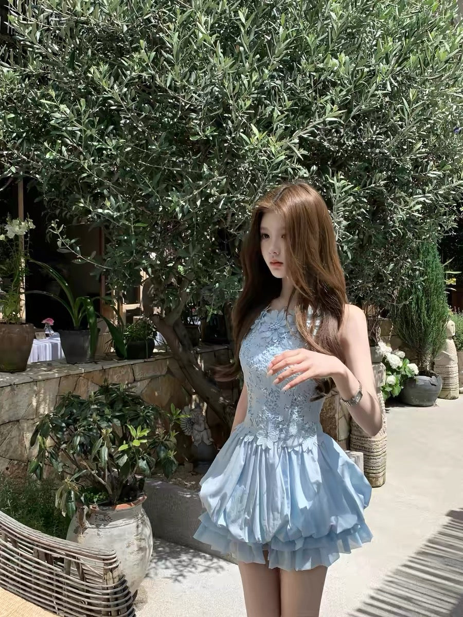 Q-Girl's "Floating Floral & Indigo" Collection: Exquisite, unique French-style princess dress featuring intricate craftsmanship, a blue sleeveless tulip-skirt silhouette, and delicate straps.