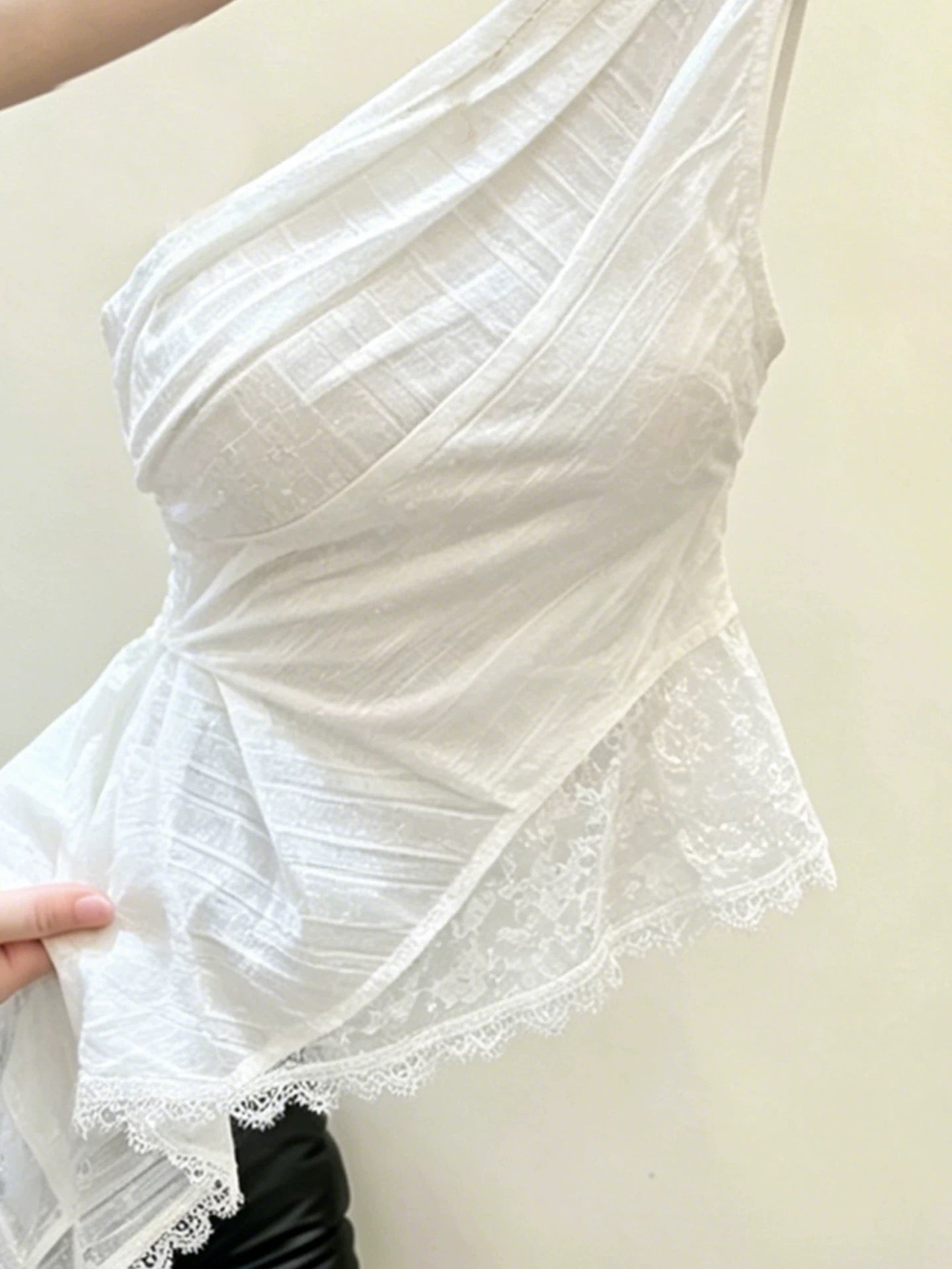 Exquisite white asymmetrical lace one-shoulder tank top—a new summer style designed to flatter the figure and create a youthful look.