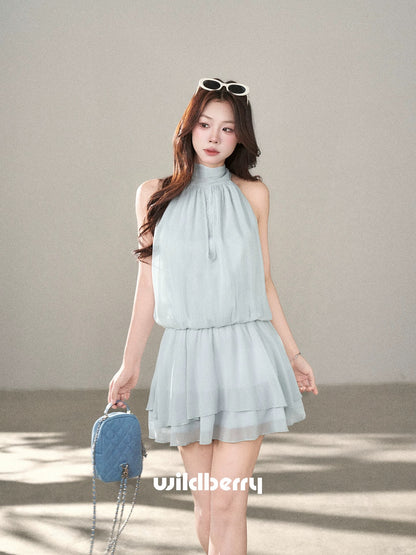 A sleeveless halter-neck dress with a wild berry design, a super cute new summer 2026 style, featuring a fitted waist and a fairy-like silhouette.