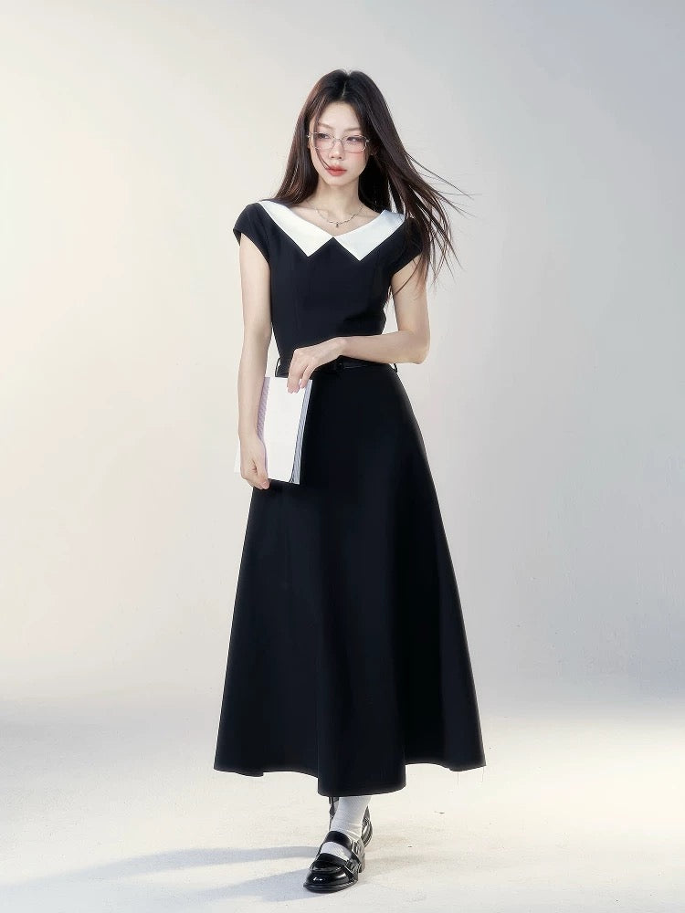 A black short-sleeved dress with a small wild berry design, a new summer style for 2026, featuring a flattering waist and a French-style long skirt.