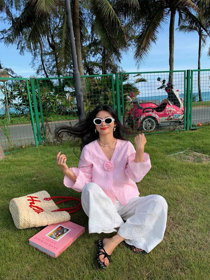 Distinctive and refined: a chic, Korean-style blouse featuring pink embroidery and a V-neck—a new long-sleeved top for 2026.