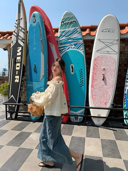 Relaxed-fit, distinctive off-shoulder blouse featuring embroidery and a unique design—a standout piece from the 2026 Spring/Summer collection.