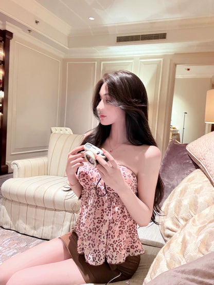 WW Original: A sexy two-piece set featuring a pink-toned, retro-style leopard print camisole and a high-waisted, brown, form-fitting mini skirt.