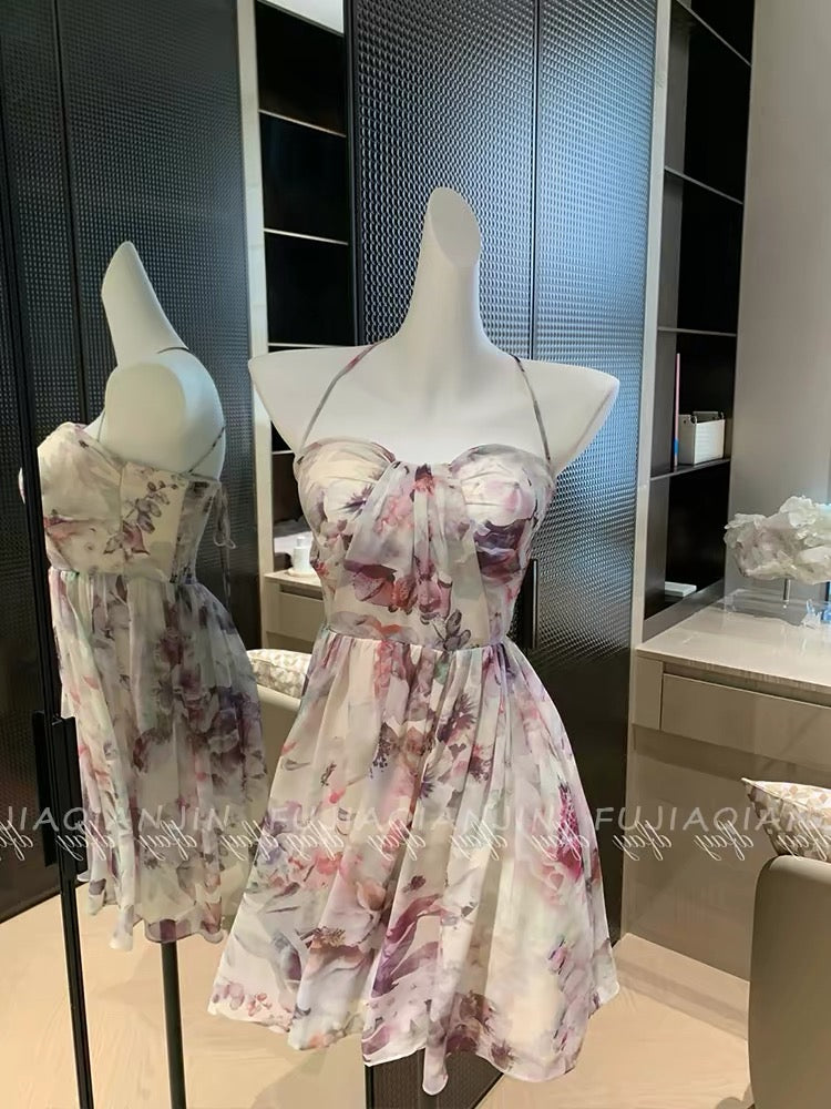 A stunning, French-style romantic dress featuring a dreamy blended print, a sleeveless strapless bodice, and a waist-cinching, slimming fit—perfect for a chic vacation look and highly photogenic.