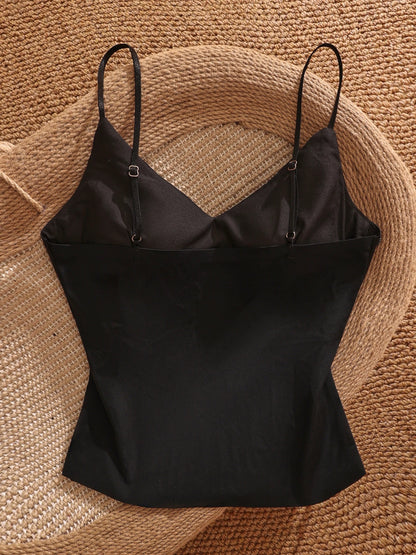 Black satin camisole with padded bra, versatile, stylish, sexy, slimming, and flattering short top for women.