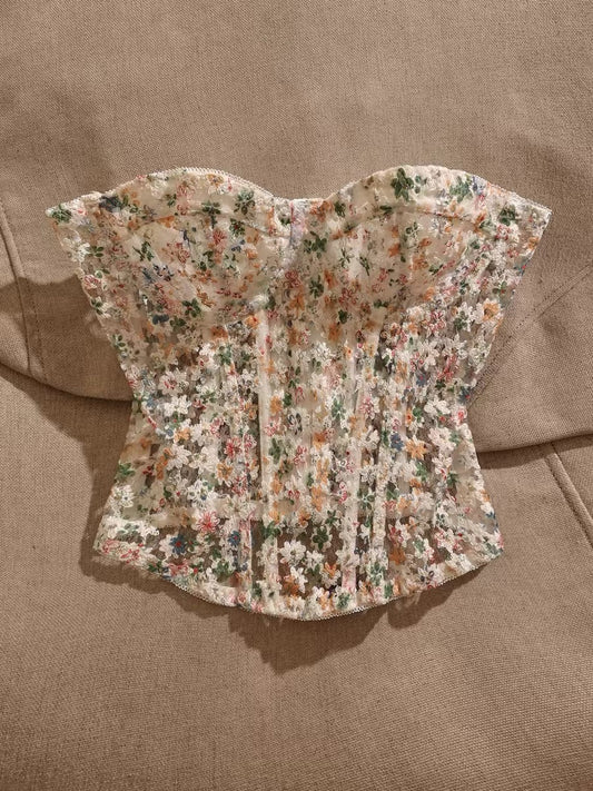 Cottagecore-style strapless bustier top featuring floral lace, embroidery, and boning; includes built-in pads and a unique design suitable for outerwear.
