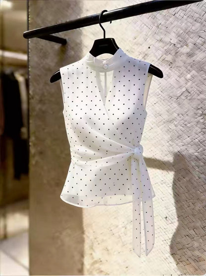 High-end, unique-design white sleeveless blouse for women featuring a polka-dot pattern, mandarin collar, tie-waist, and a slimming fit—perfect for summer.