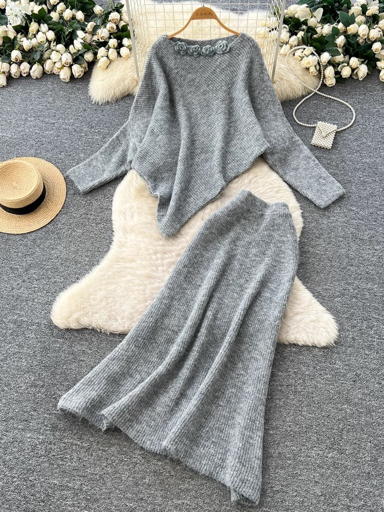 Gentle and elegant women's autumn and winter outfit: loose-fitting, irregularly shaped sweater with three-dimensional floral pattern and high-waisted knitted skirt.