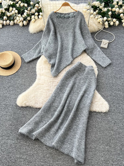 Gentle and elegant women's autumn and winter outfit: loose-fitting, irregularly shaped sweater with three-dimensional floral pattern and high-waisted knitted skirt.