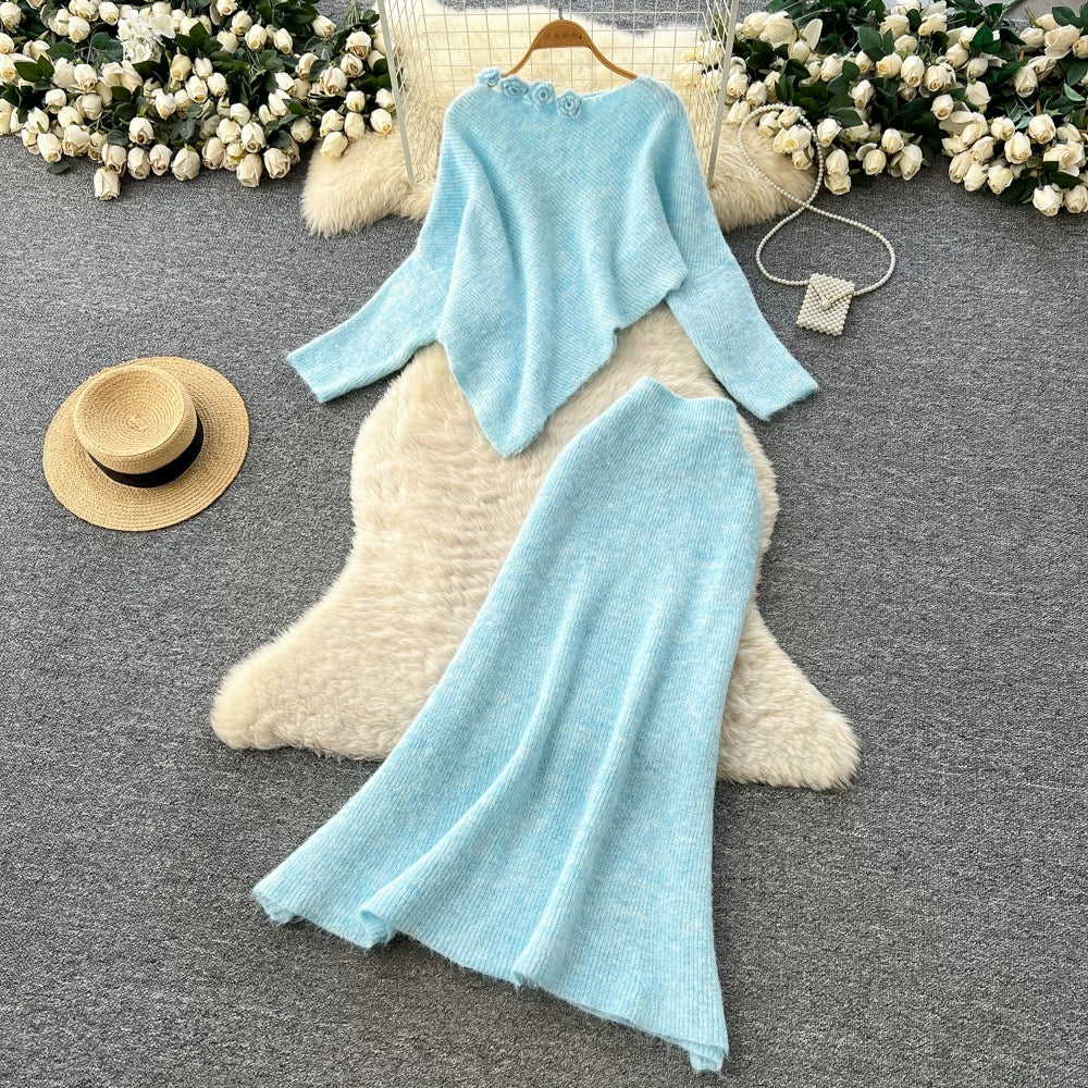 Gentle and elegant women's autumn and winter outfit: loose-fitting, irregularly shaped sweater with three-dimensional floral pattern and high-waisted knitted skirt.