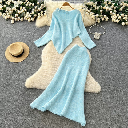 Gentle and elegant women's autumn and winter outfit: loose-fitting, irregularly shaped sweater with three-dimensional floral pattern and high-waisted knitted skirt.