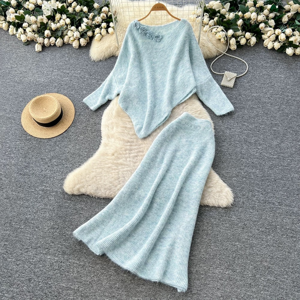 Gentle and elegant women's autumn and winter outfit: loose-fitting, irregularly shaped sweater with three-dimensional floral pattern and high-waisted knitted skirt.