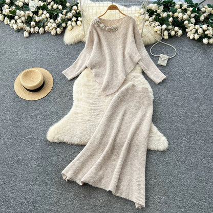 Gentle and elegant women's autumn and winter outfit: loose-fitting, irregularly shaped sweater with three-dimensional floral pattern and high-waisted knitted skirt.