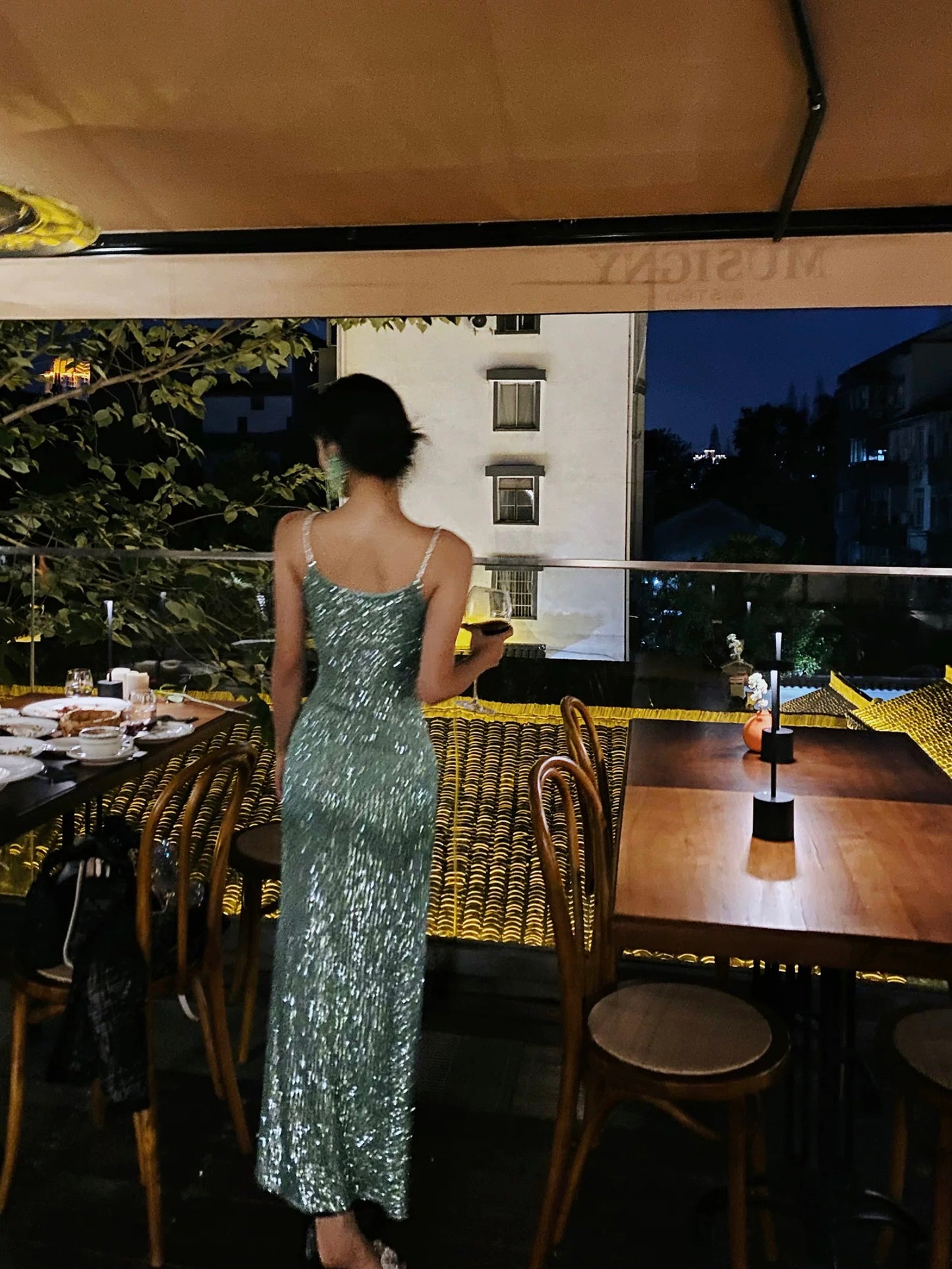 A sophisticated green sequined evening gown, a figure-hugging, sexy shimmering slip dress, perfect for a birthday party or small gift.