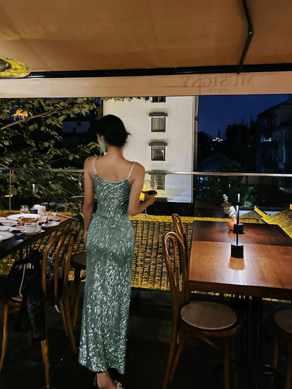 A sophisticated green sequined evening gown, a figure-hugging, sexy shimmering slip dress, perfect for a birthday party or small gift.