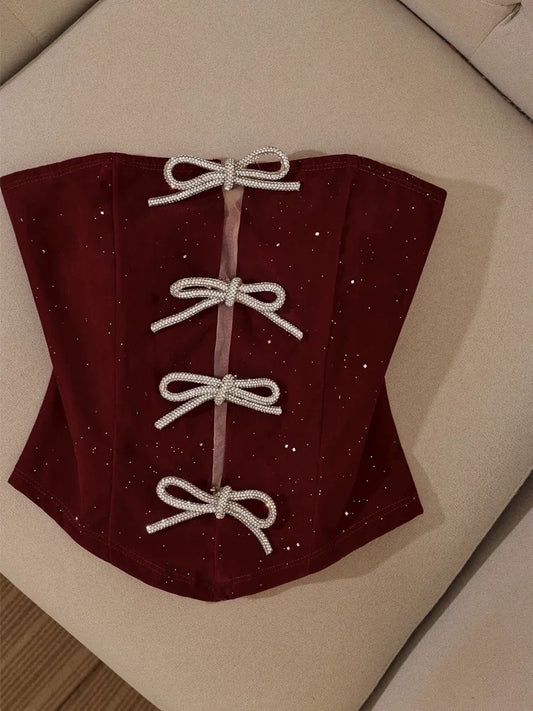 Christmas outfit: Strapless bow camisole top layered over a suit jacket; sexy off-the-shoulder tube top for women.