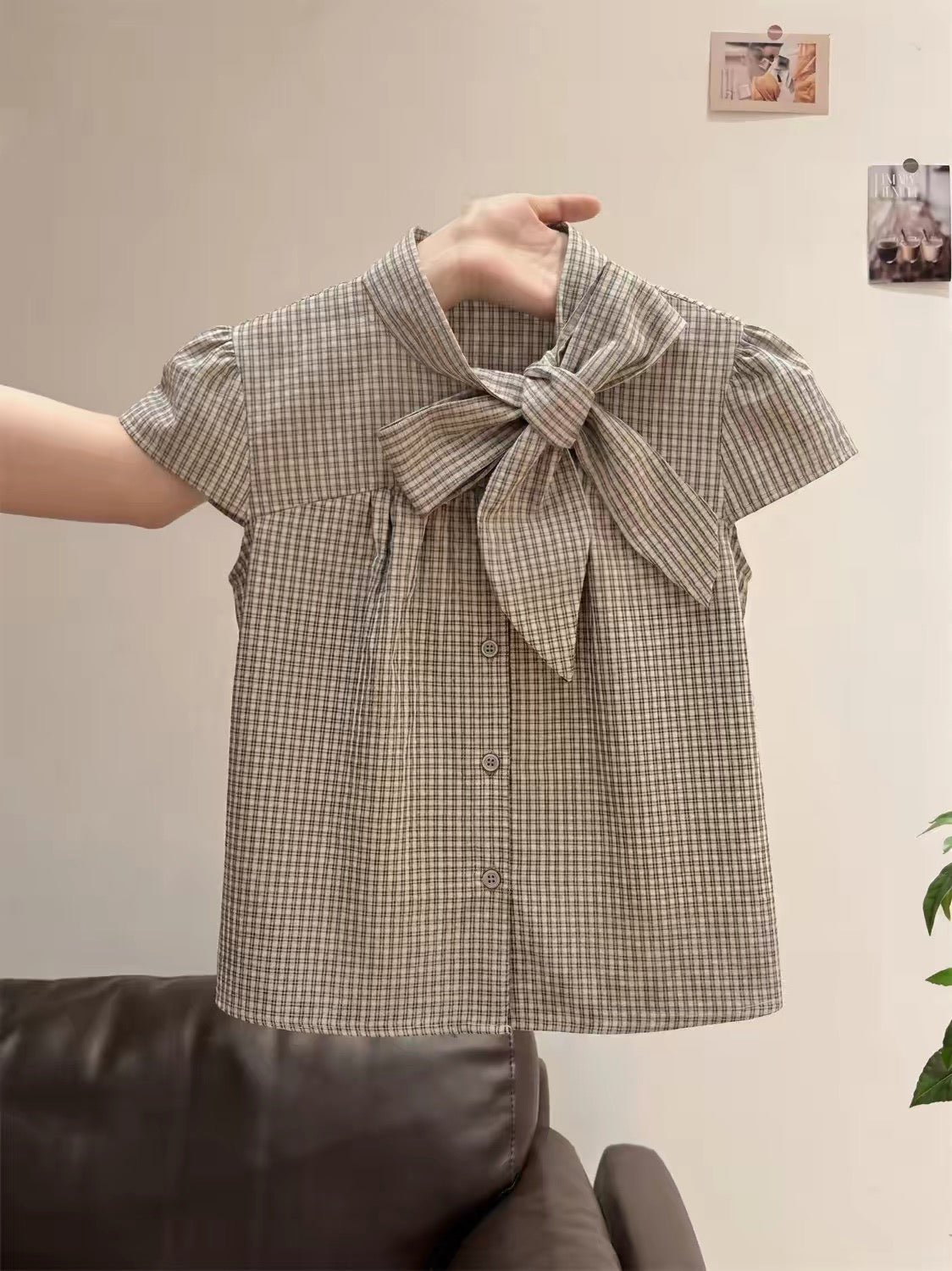 Unisex retro plaid short-sleeve top featuring a mandarin collar, bow-tie detail, and flattering flutter sleeves—perfect for a chic, intellectual summer look.