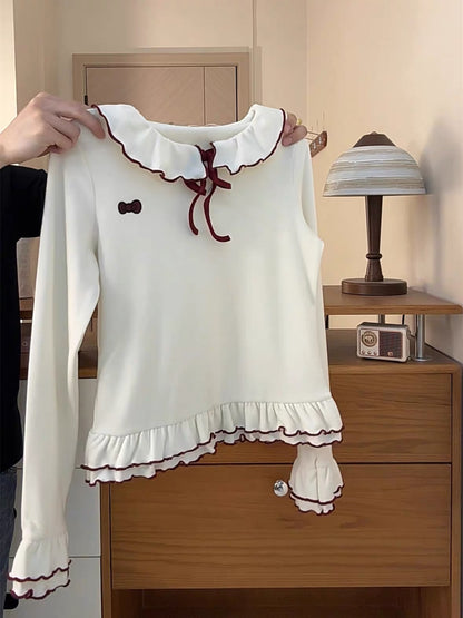 This fresh and stylish women's top features a color-blocked design, rolled-up hem, tie-up Peter Pan collar, and a thickened style. It also boasts a unique double-layered ruffled hem and long sleeves.