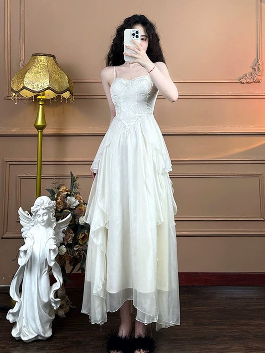 Mrs. Xiao's white French suspender dress for women's pure desire tea break slimming irregular seaside vacation fairy dress summer