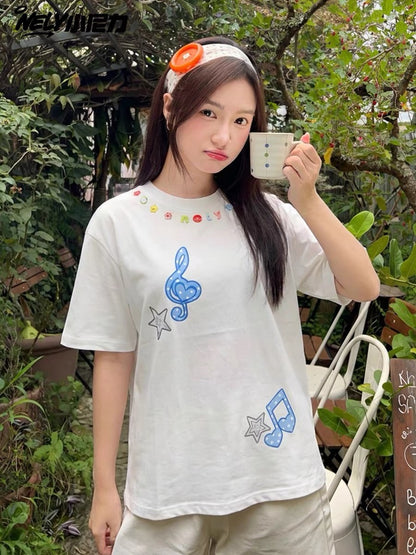 Unisex loose-fit short-sleeve T-shirt featuring a musical note and star appliqué; a versatile, casual crew-neck top with a unique, distinctive design.