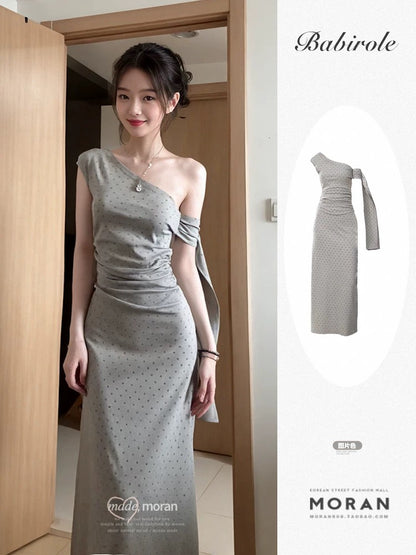 Sophisticated grey off-shoulder dress with a unique, minimalist design; a new summer 2025 style; fitted waist and elegant long dress.
