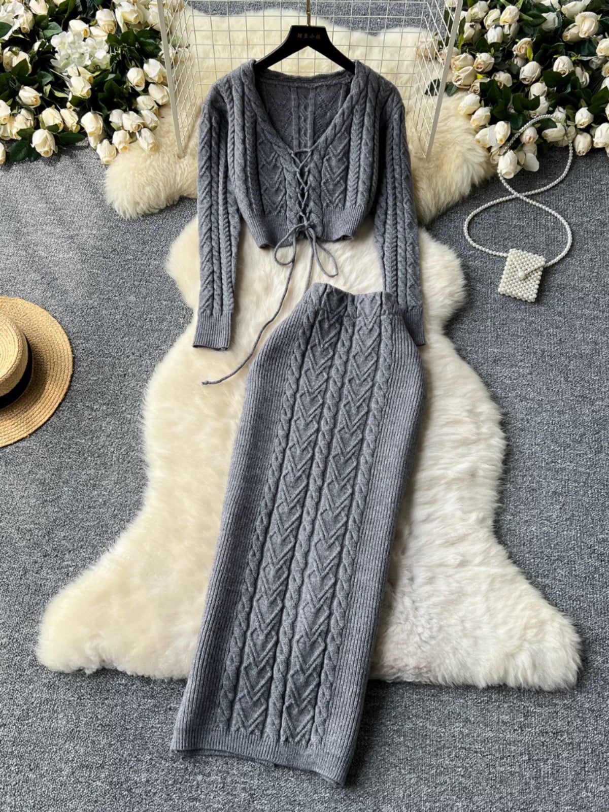 New autumn and winter design sense hollow strap short belly-exposed knitted top + ultra-high waist cable sweater skirt