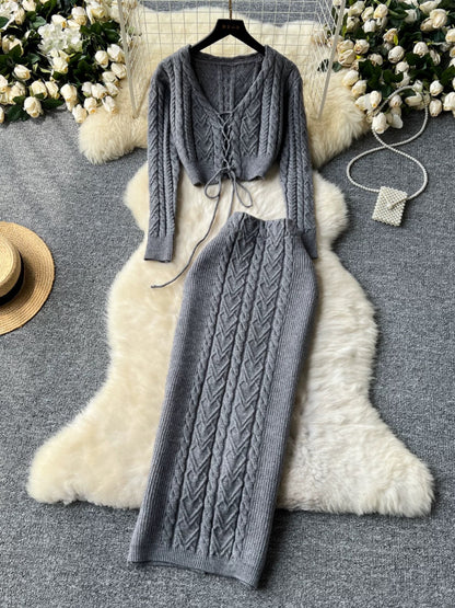 New autumn and winter design sense hollow strap short belly-exposed knitted top + ultra-high waist cable sweater skirt