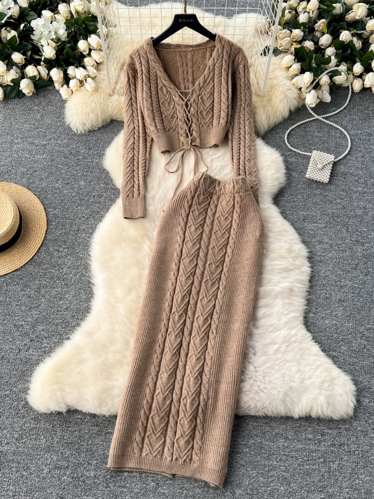 New autumn and winter design sense hollow strap short belly-exposed knitted top + ultra-high waist cable sweater skirt