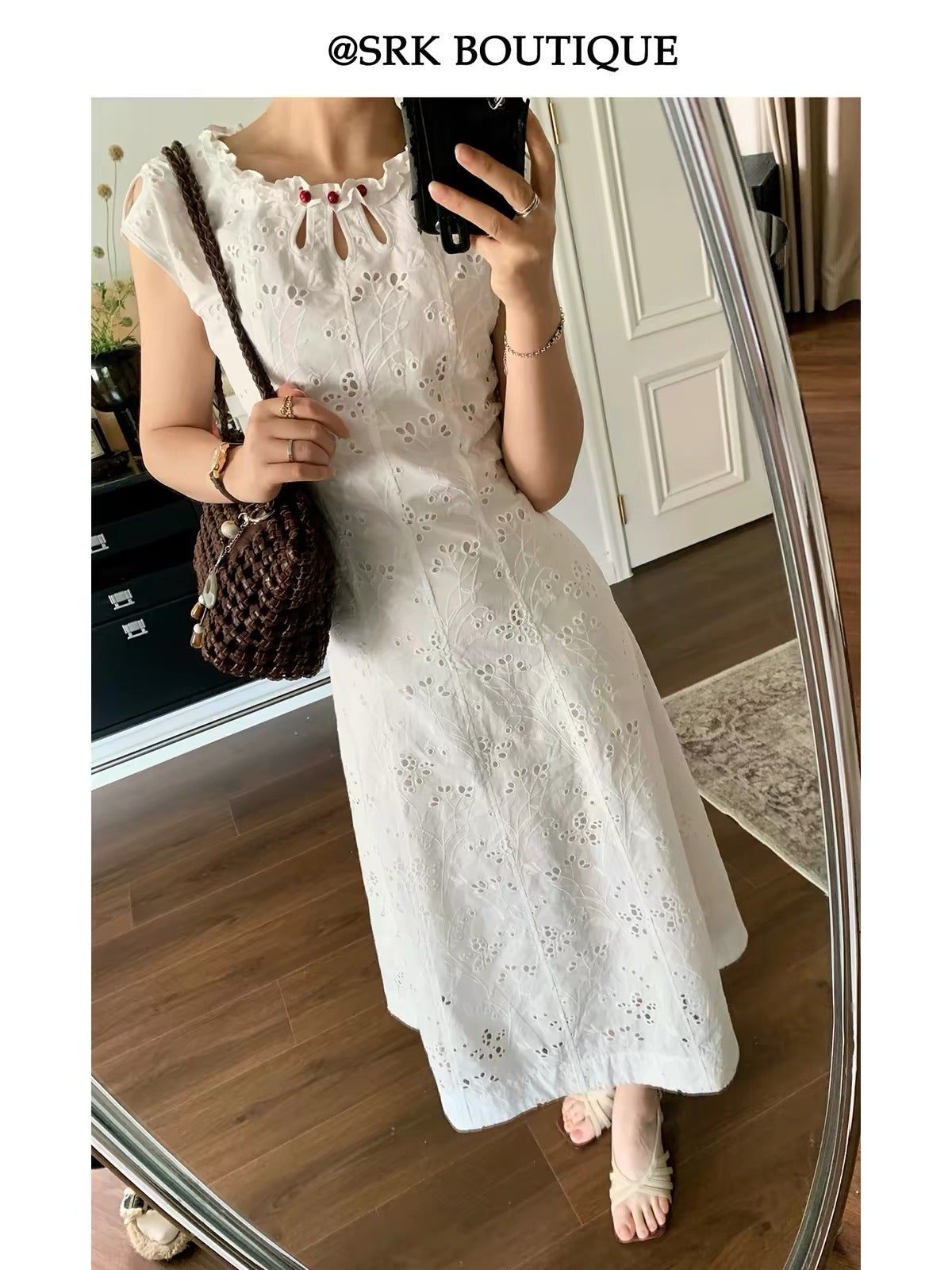 SRK French-style sleeveless A-line maxi dress in white, featuring intricate embroidery, a waist-cinching silhouette, and a minimalist, elegant aesthetic.