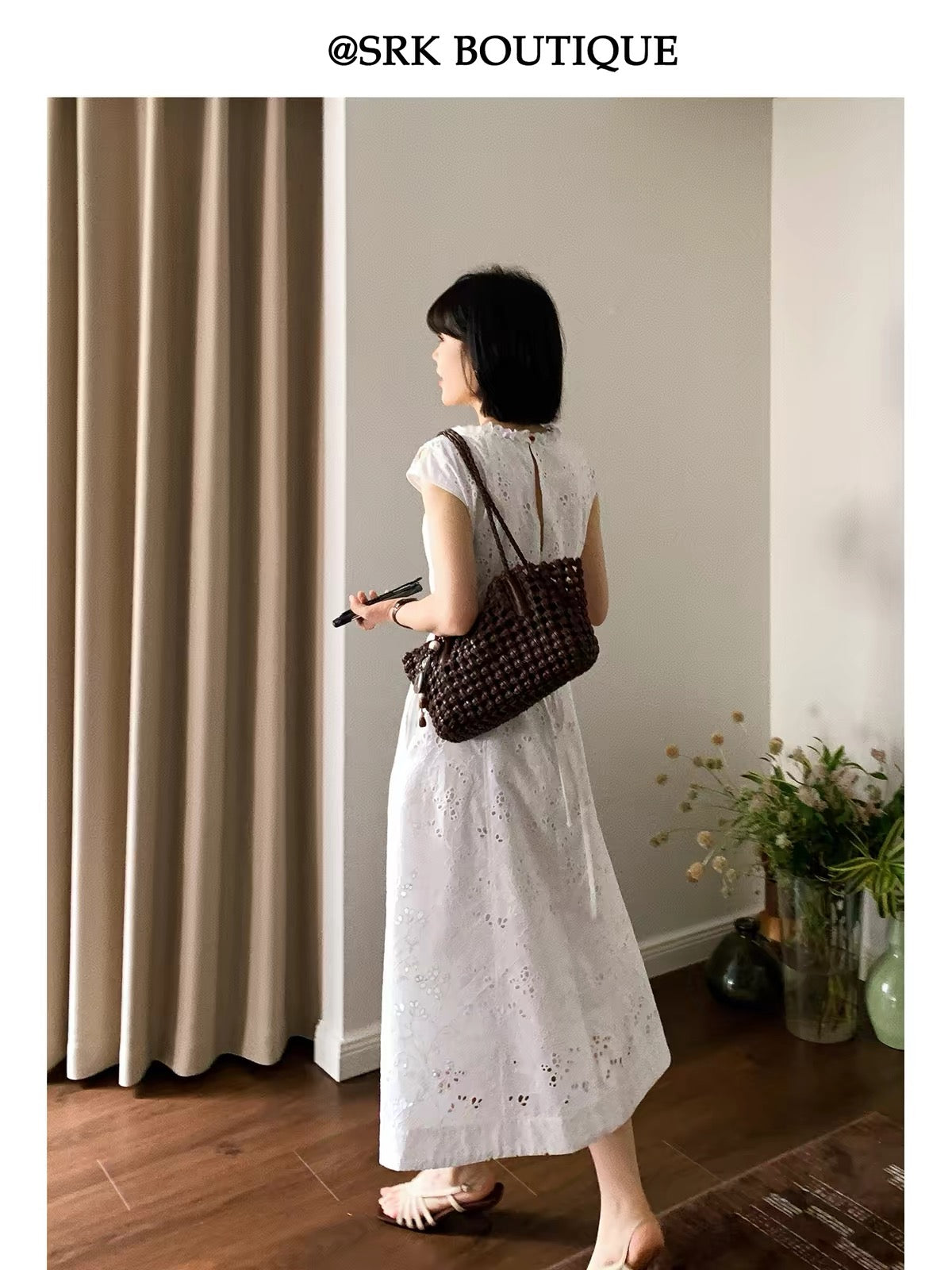 SRK French-style sleeveless A-line maxi dress in white, featuring intricate embroidery, a waist-cinching silhouette, and a minimalist, elegant aesthetic.