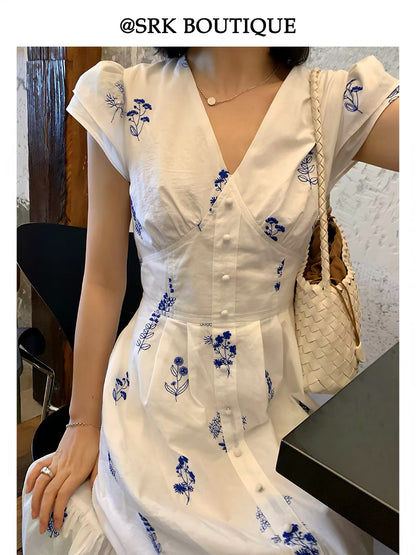 SRK French-style embroidered white dress featuring delicate flutter sleeves, a slimming V-neck, and a waist-defining fit—an elegant, ethereal, and unique piece.